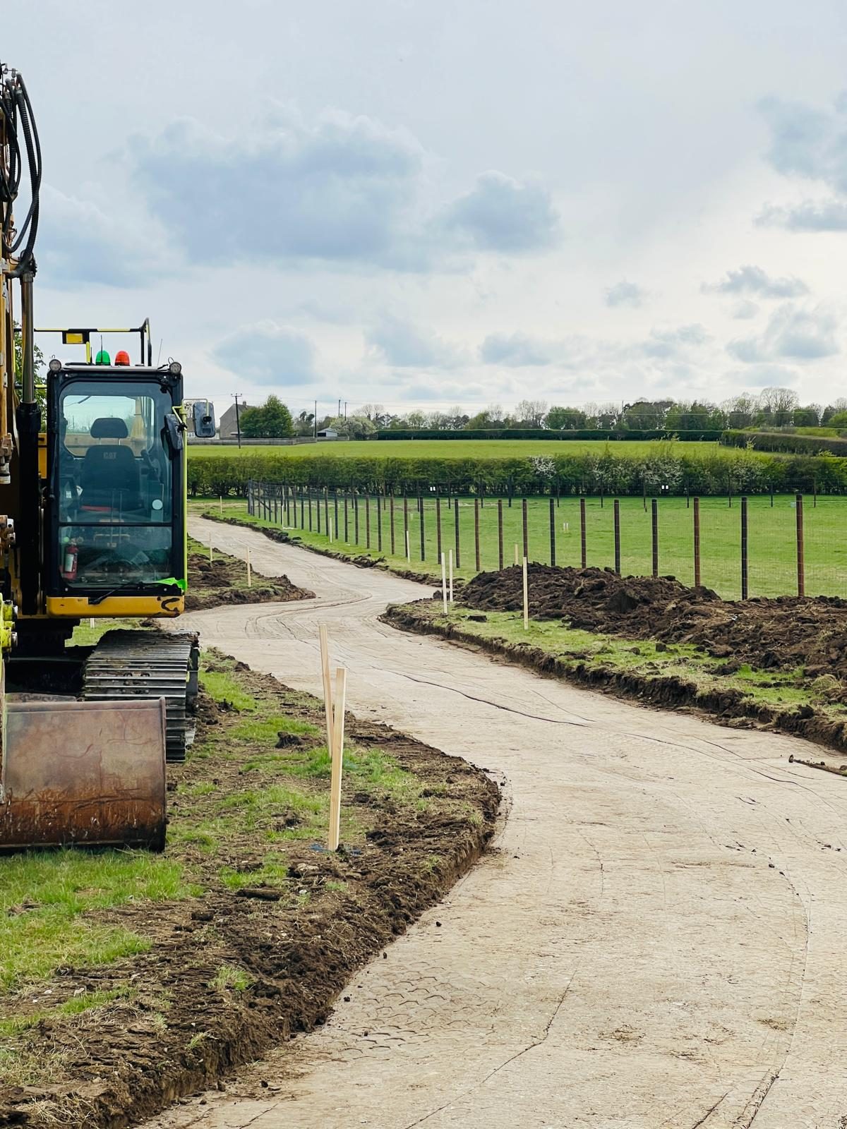 A newly formed haul road curving through fields at a 24MW solar site in Cambridgeshire.