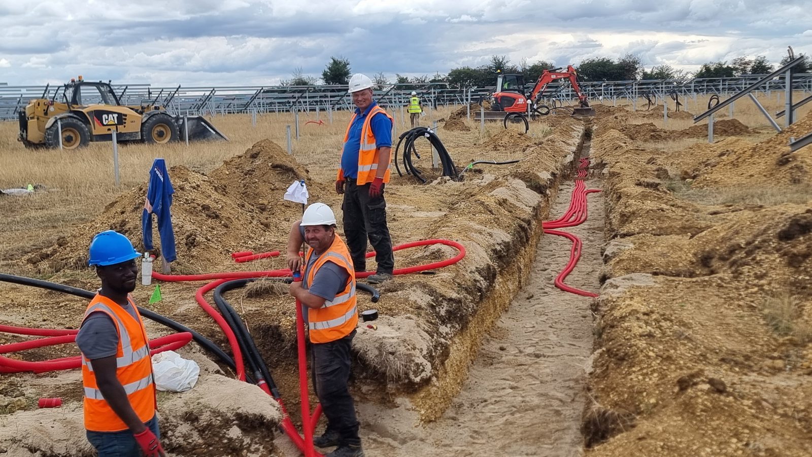 Cable ducting being installed in a trench.