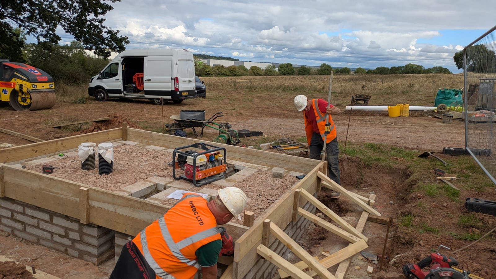 Operatives building the blockwork perimeter and timber shuttering for a reinforced concrete equipment base.