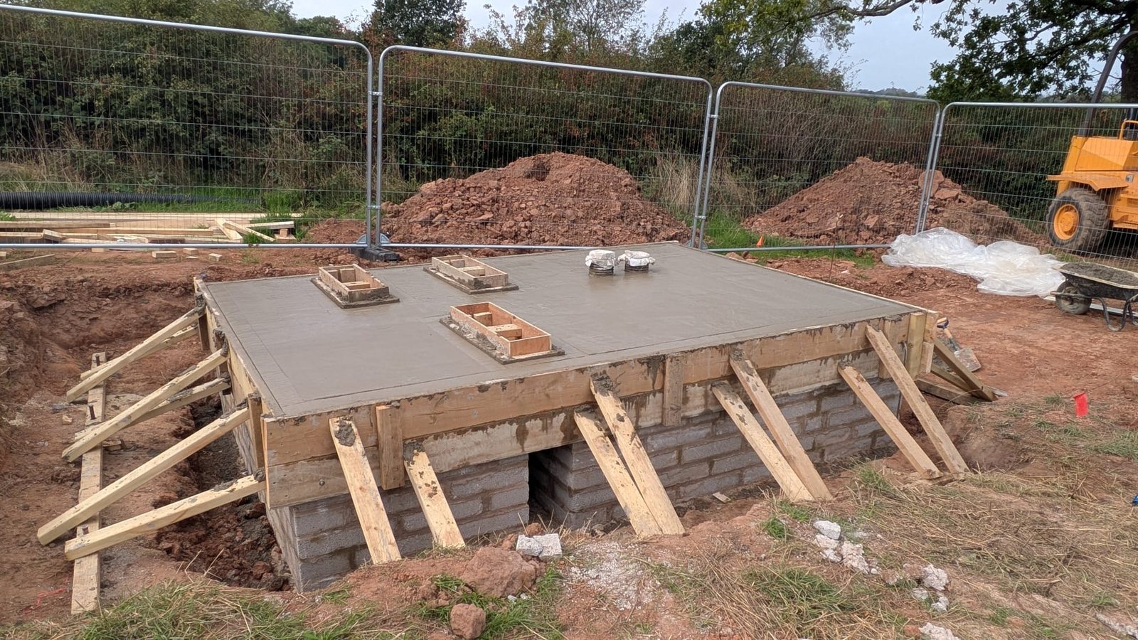 The finished concrete base, floated level with cast-in fixings ready for the equipment.