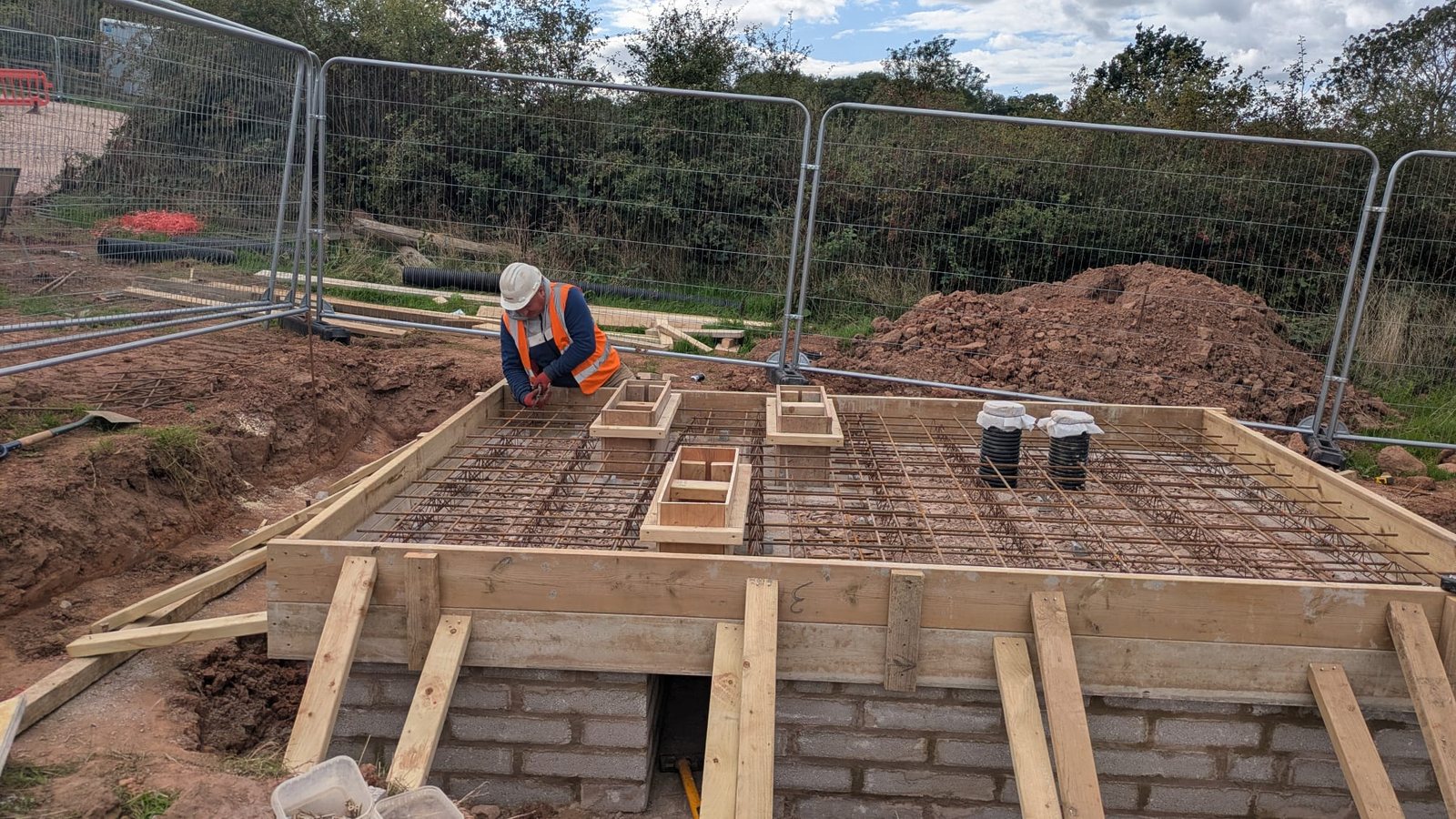 A reinforcement mat fixed inside the shutter with cast-in boxes set in position before the pour.