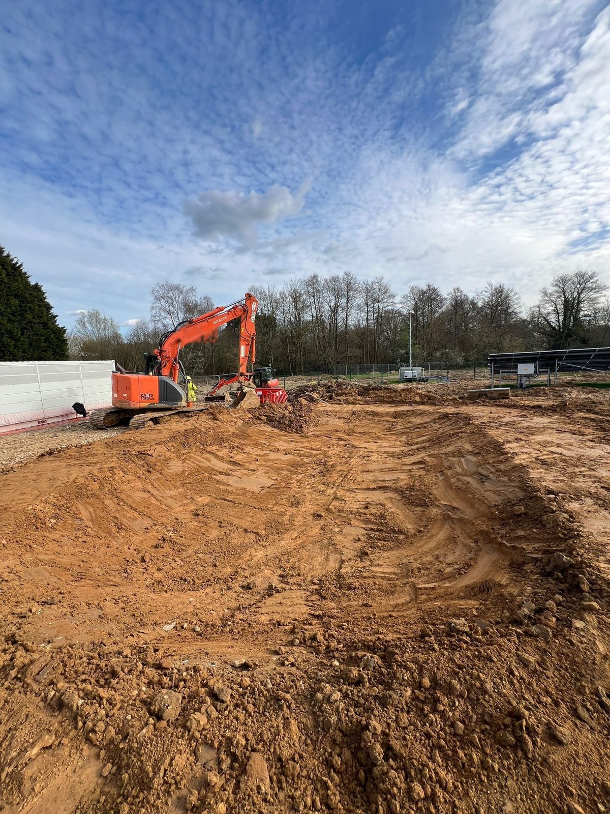 An excavator working a balancing pond.
