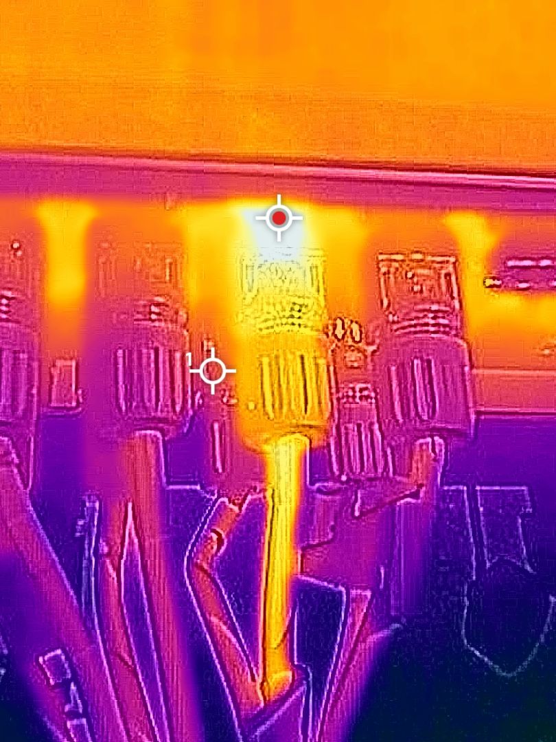 Thermal image of a row of DC cable connectors, with one connector at 49&deg;C while its neighbours read around 35.7&deg;C.