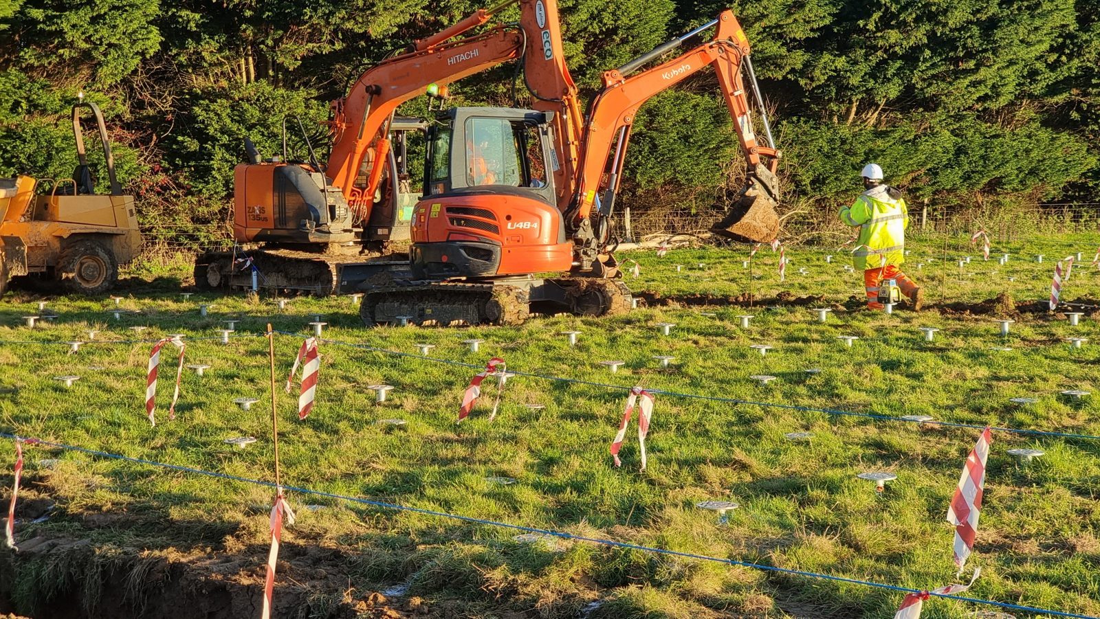 Rows of screw pile foundations marked out across a field at a solar and battery storage site where HWBC carried out the civils.